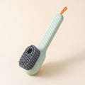 Brosse KleanKicks vert sauge à réservoir avec poils gris, manche strié et boucle orange